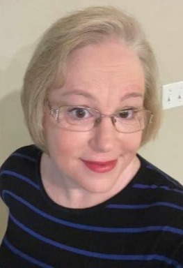 Wendy Reinhardt in a black and blue shirt smiling